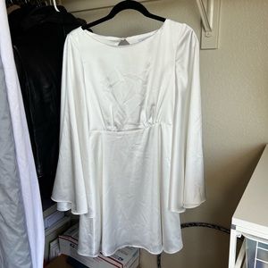 White satin dress with bell sleeves and open back
